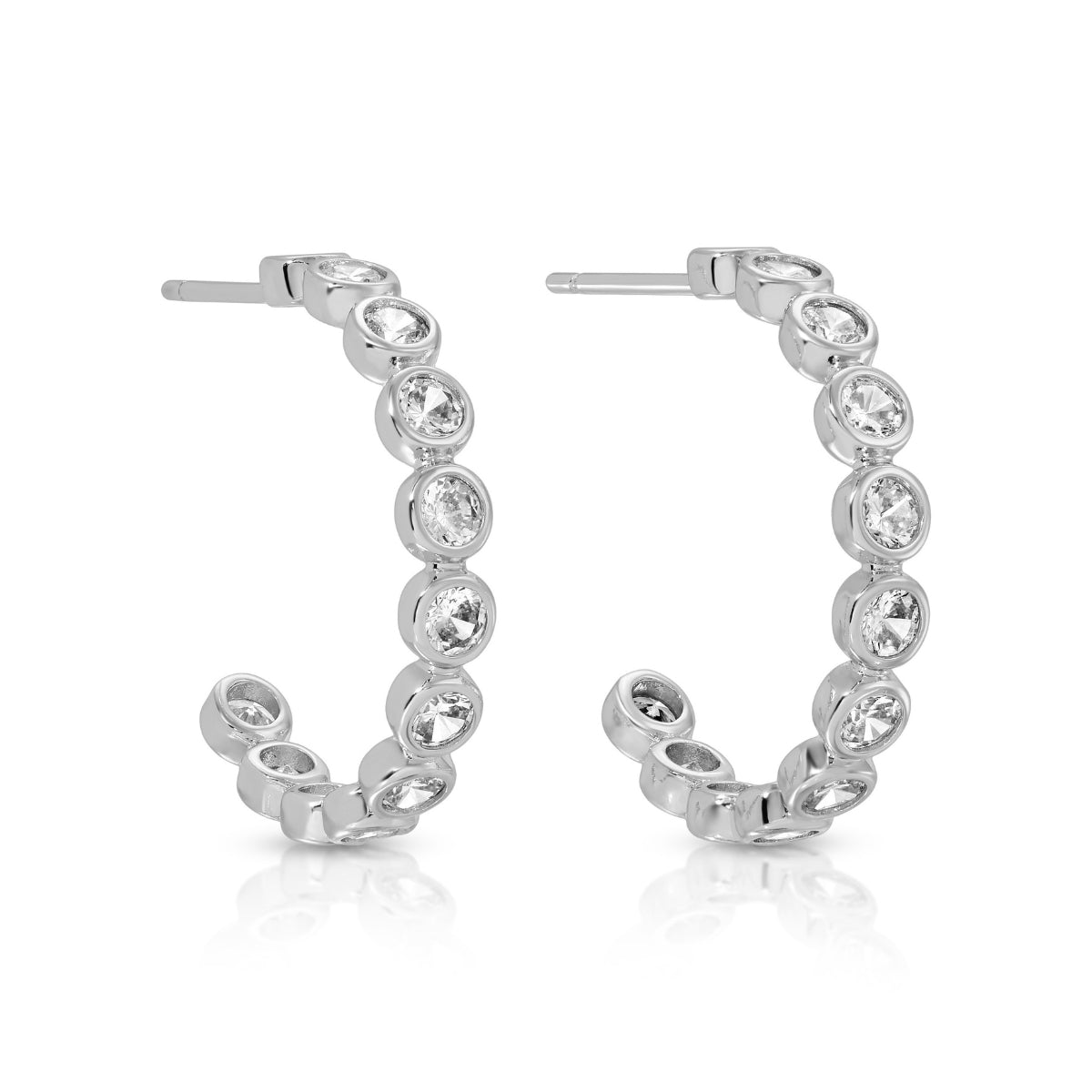 Silver hoop earrings with clear gemstones on a white background