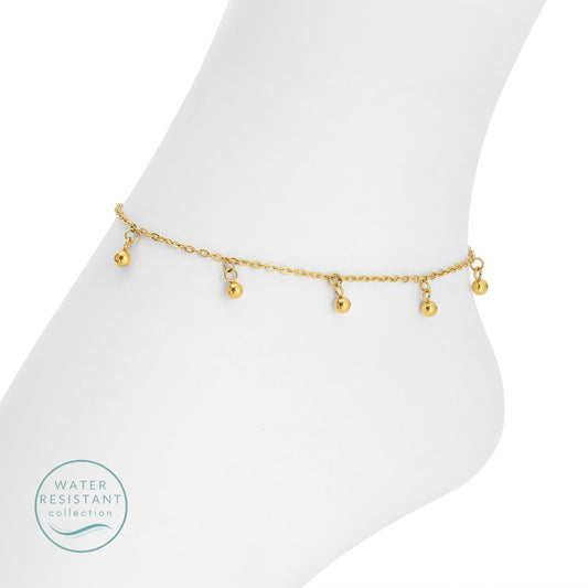 Gold anklet on a foot with 'Water Resistant' collection label.