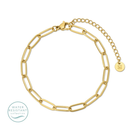 Gold chain bracelet with a small round tag on a white background