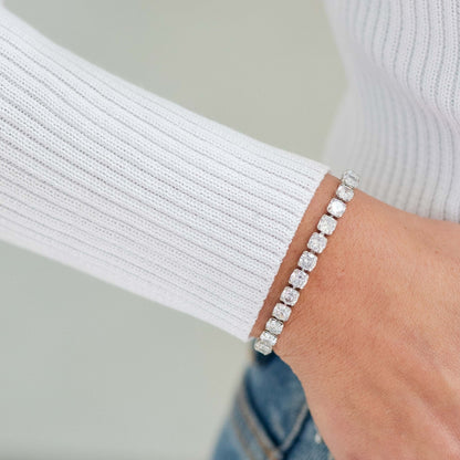 Silver bracelet on a wrist with a blurred background