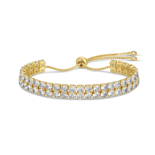 Gold bracelet with clear stones on a white background