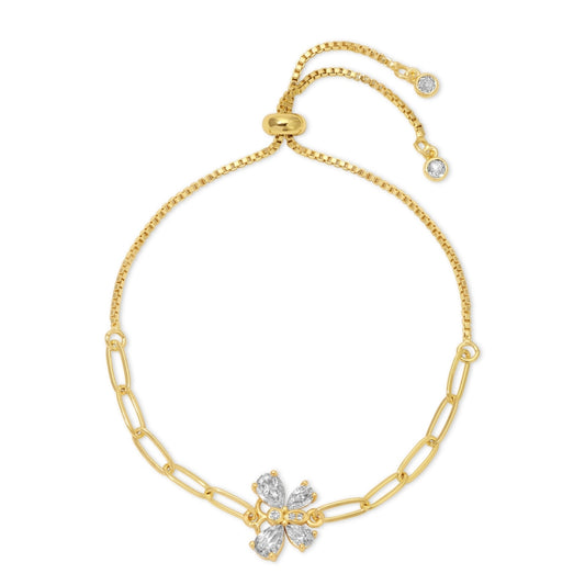 Gold bracelet with a floral clasp on a white background