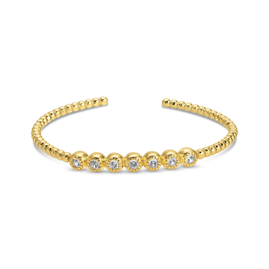 Gold bracelet with embedded diamonds on a white background