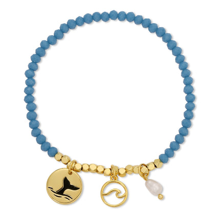 Blue beaded bracelet with gold charms on a white background