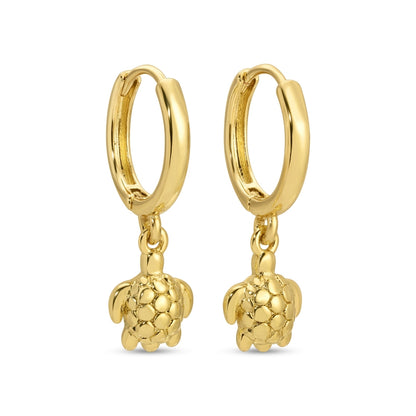 Gold hoop earrings with turtle charms on a white background