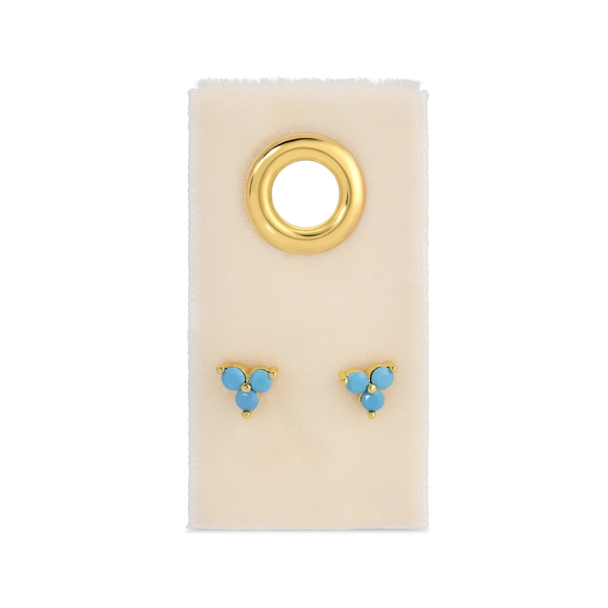 Gold and turquoise earrings on a beige card with a white background