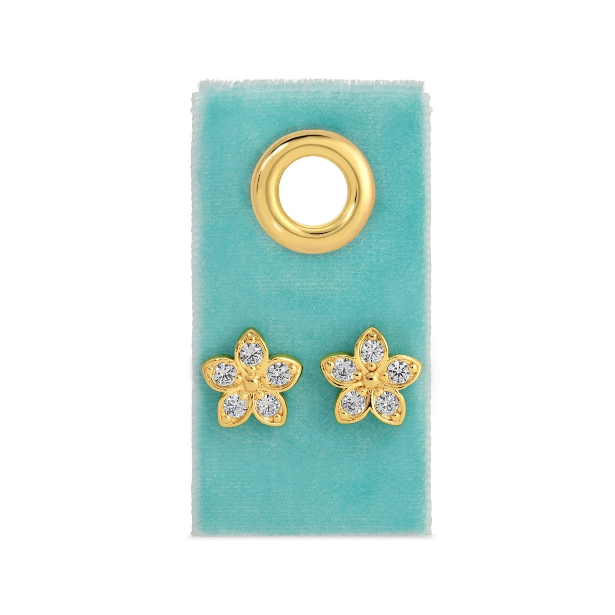 Gold flower-shaped earrings with clear stones on a green card
