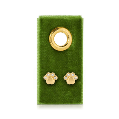 Gold paw print earrings on a green velvet card