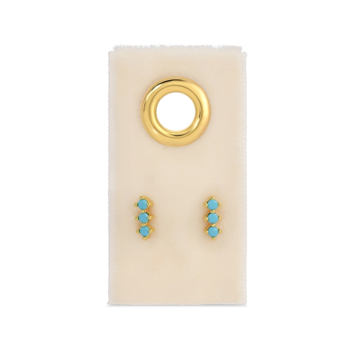 Gold and turquoise earrings on a white card with a gold ring design.