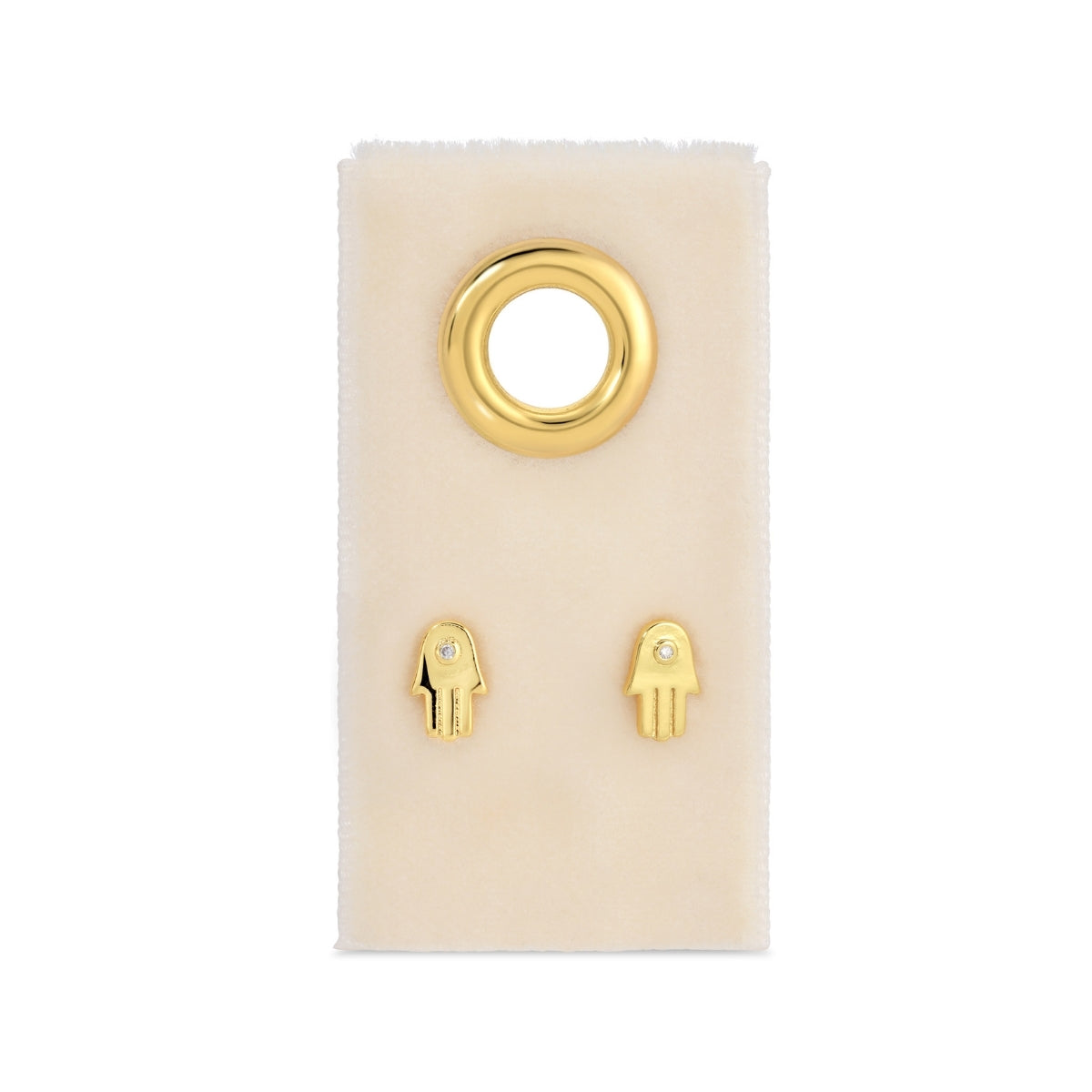 Gold hamsa hand earrings on a white card with a white background