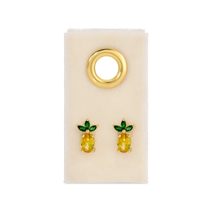 Pineapple-shaped earrings on a beige card with a gold hoop.