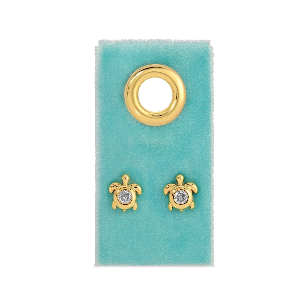 Gold turtle earrings with gemstones on a turquoise card