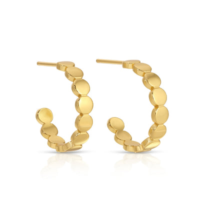 Gold hoop earrings with round discs on a white background