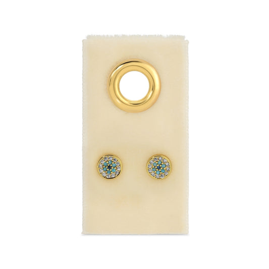 Gold earrings with gemstones on a beige card against a white background