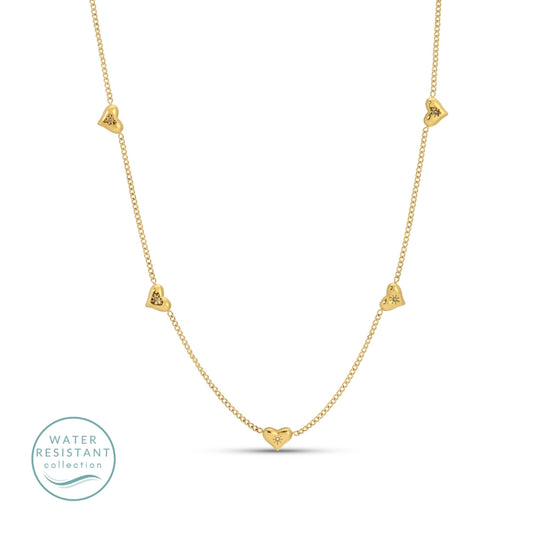 Gold necklace with heart-shaped pendants on a white background