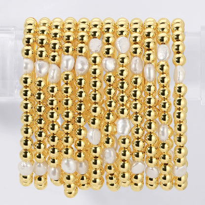 Gold and pearl beaded bracelet on a white background