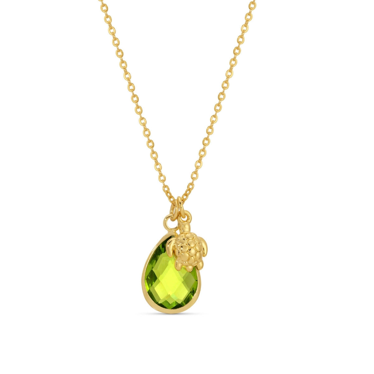 Gold necklace with a green gemstone pendant on a white background