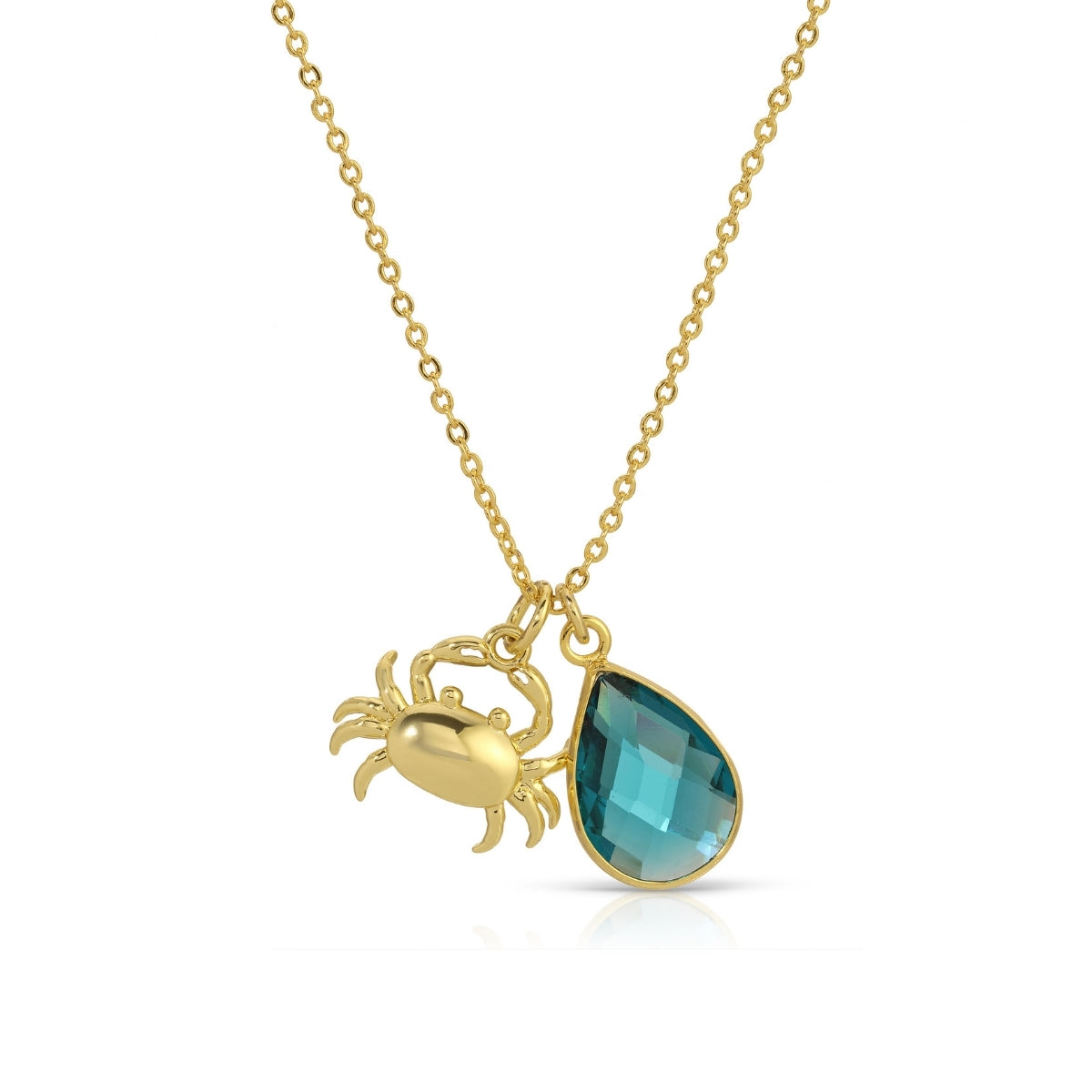Gold necklace with a crab charm and blue teardrop pendant on a white background
