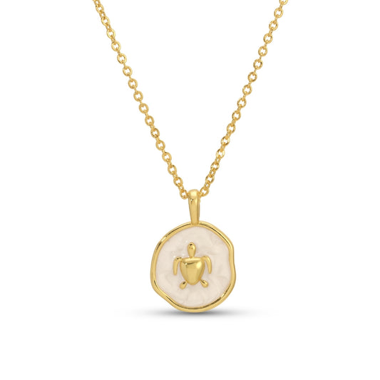 Gold necklace with a round pendant featuring a heart and figure on a white background