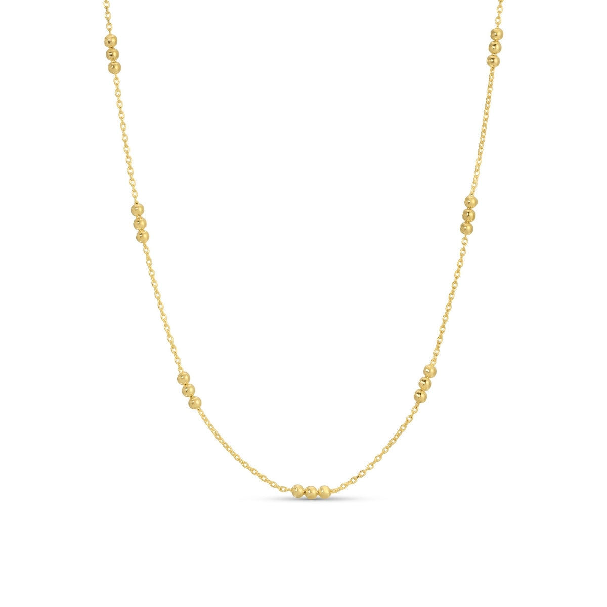 Gold necklace with small beads on a white background