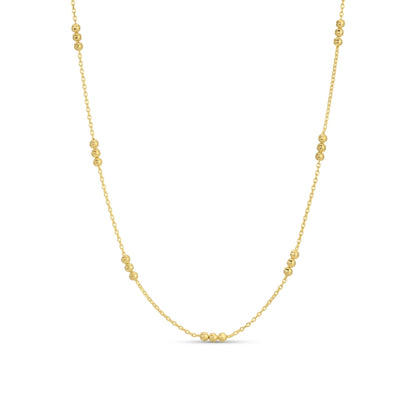 Gold necklace with small beads on a white background