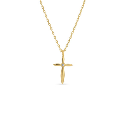 Gold cross necklace with a diamond on a white background