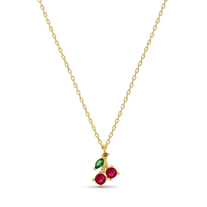 Gold necklace with red and green gemstones on a white background