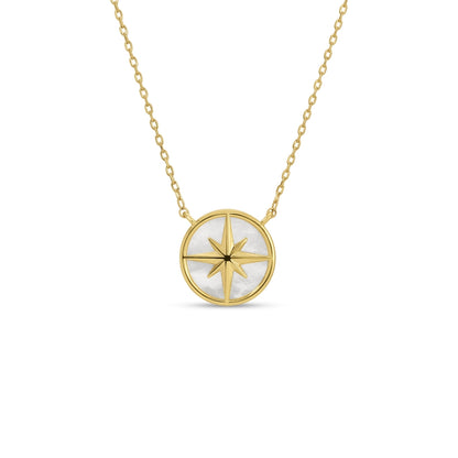 Gold necklace with a circular pendant featuring a star design on a white background