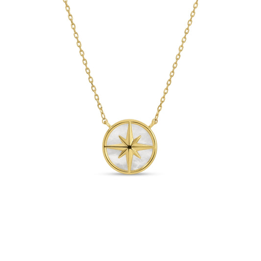 Gold necklace with a circular pendant featuring a star design on a white background