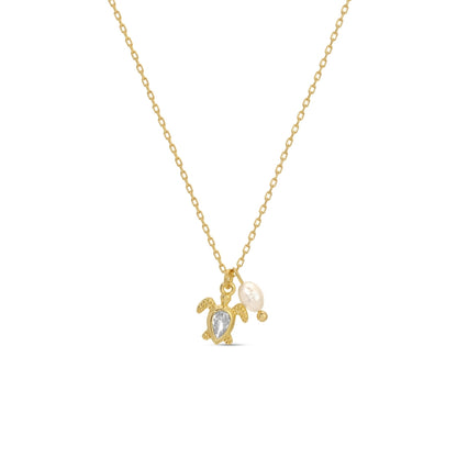 Gold necklace with turtle and pearl pendant on a white background