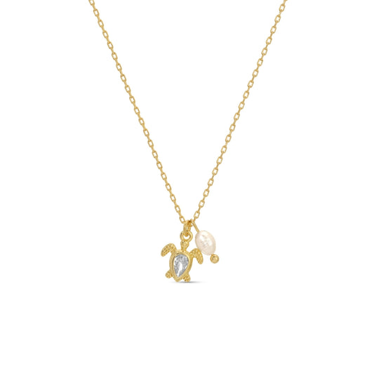 Gold necklace with turtle and pearl pendant on a white background