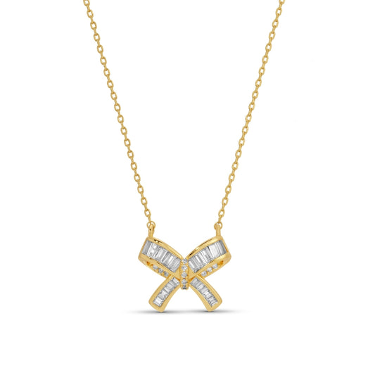Gold necklace with a bow-shaped pendant on a white background