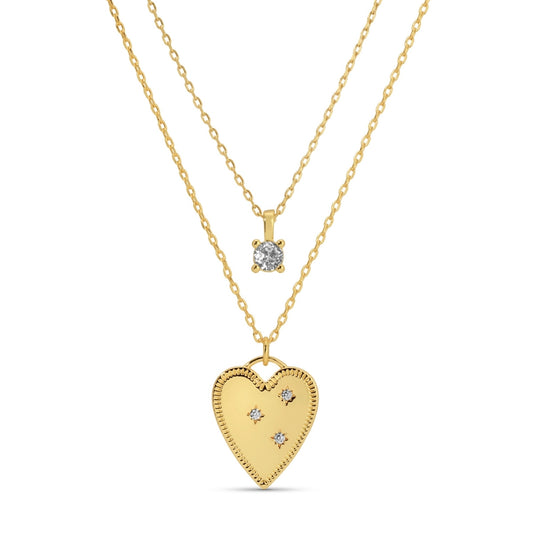 Gold heart-shaped pendant and diamond necklace on a white background