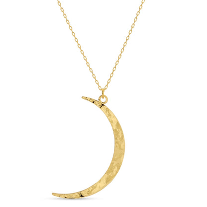 Gold crescent moon necklace on a white background
